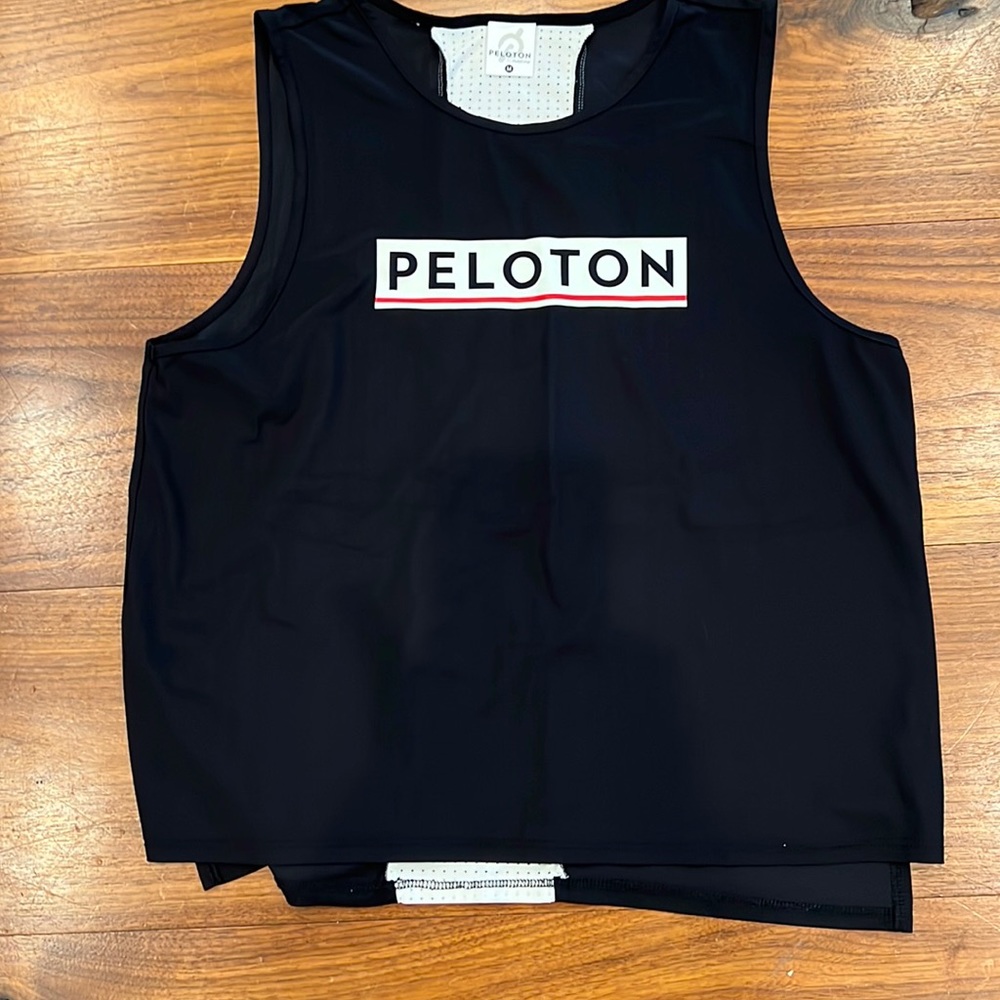 Peloton collaboration with Fila. Black tank with white mesh stripe on back! Rare